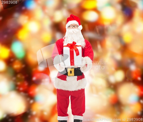 Image of man in costume of santa claus with gift box