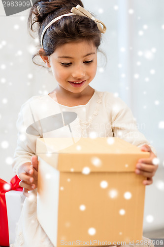 Image of smiling little girl with gift box