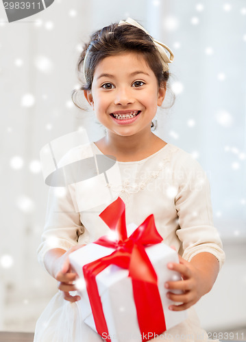 Image of smiling little girl with gift box