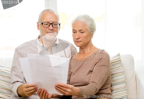 Image of senior couple with papers at home