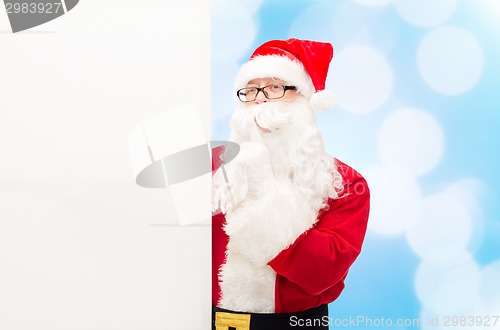 Image of man in costume of santa claus with billboard