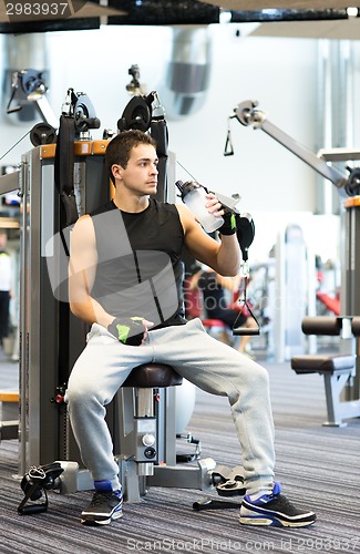 Image of man exercising on gym machine