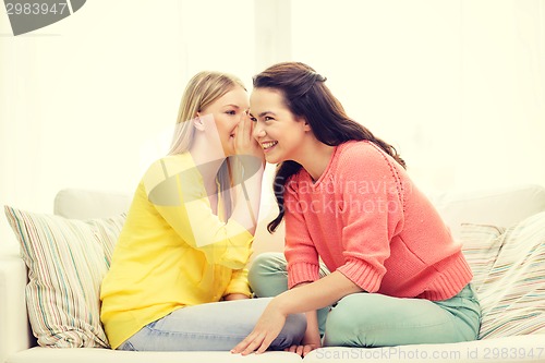 Image of one girl telling another secret