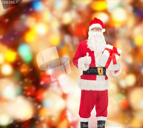 Image of man in costume of santa claus with gift box
