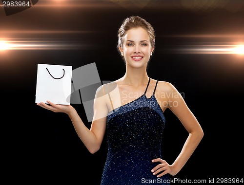 Image of smiling woman with white blank shopping bag