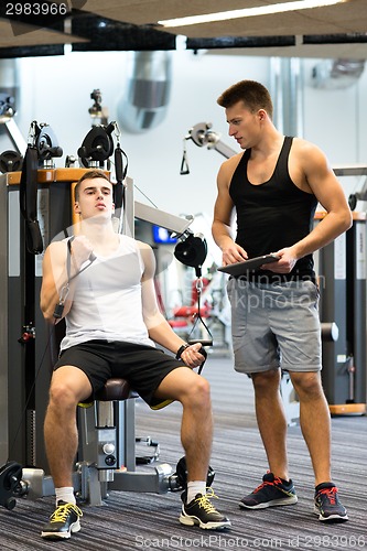 Image of man exercising on gym machine