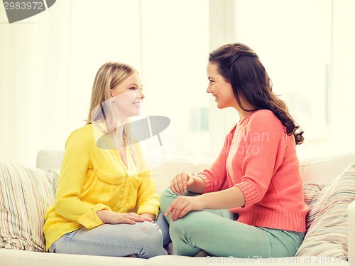 Image of two girlfriends having a talk at home