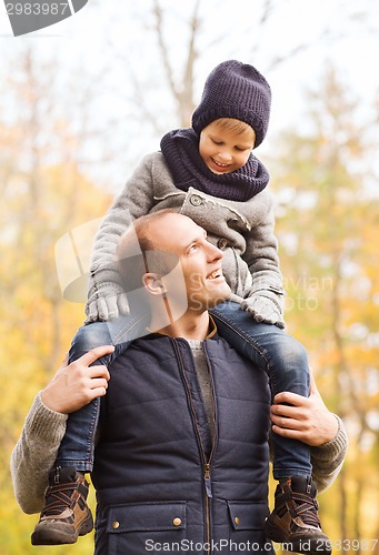 Image of happy family having fun in autumn park