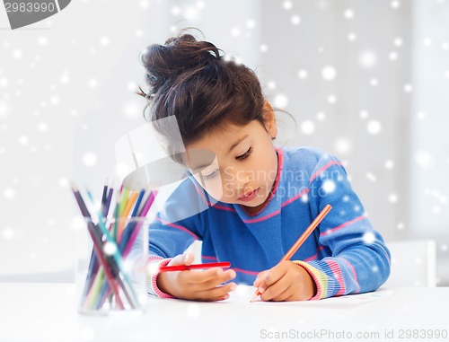 Image of little girl with pencils drawing at home