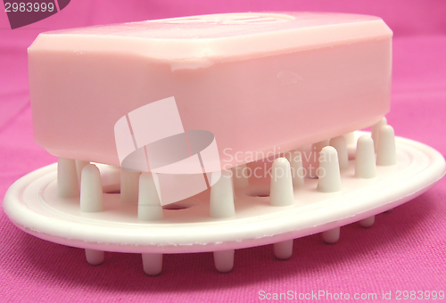 Image of Pink soap on a soap dish on a pink background