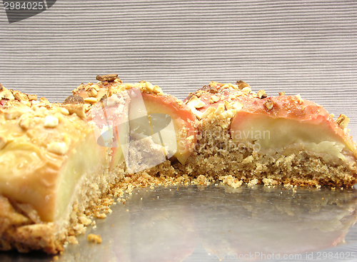 Image of Cutted  wholemeal apple cake on a cake tray on gray background