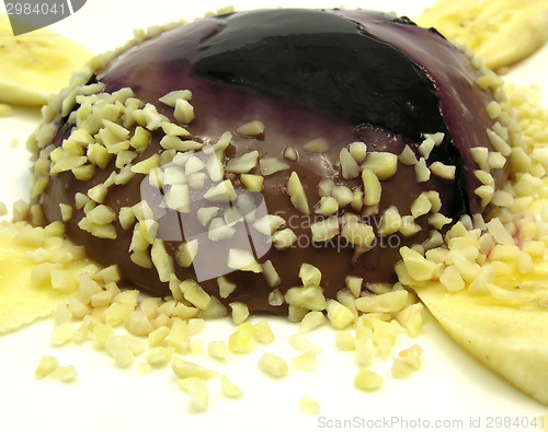 Image of Chocolate pudding with blueberries, banana and pieces of almonds