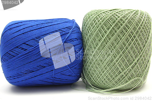 Image of Two balls of wool  in blue and green on white