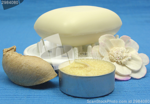 Image of Beige soap with decoration articles on a light blue background