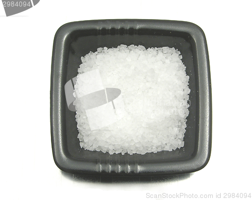 Image of Black bowl of chinaware with salt on reflecting surface