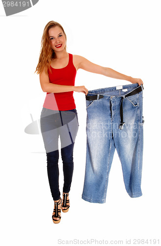 Image of Woman holding big pants.