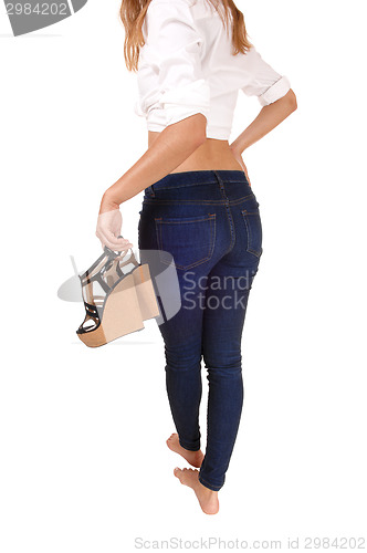 Image of Girl carrying her heels.