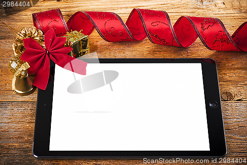 Image of tablet pc with  christmas decorations on wooden background