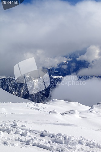 Image of View on winter snowy mountains in clouds