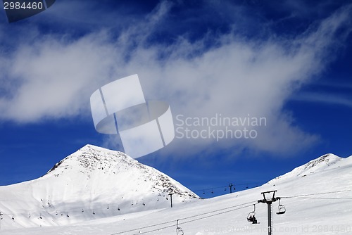 Image of Chair-lift and ski slope at sun day