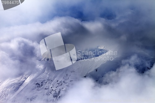 Image of Off-piste slope in sunlight multicolor clouds