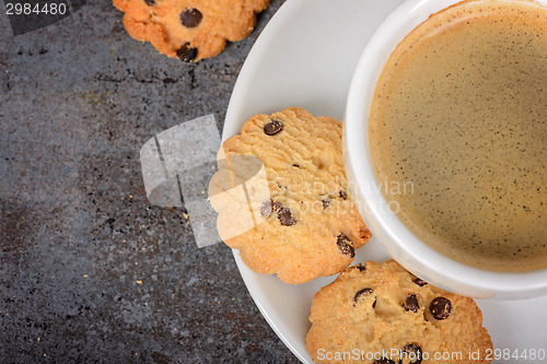 Image of Cup of fresh coffee with cookies on table