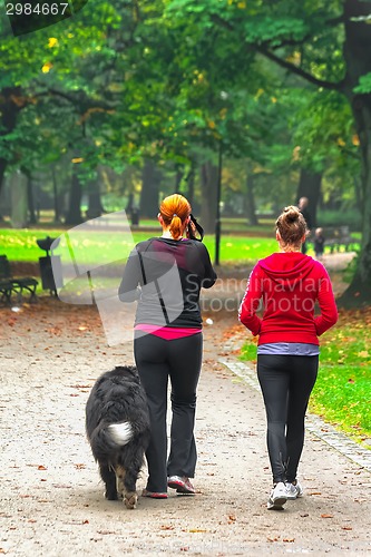 Image of Two teenage with dog