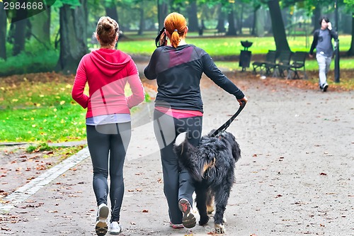 Image of Two teenage with dog