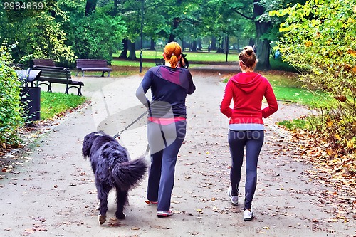 Image of Two teenage with dog