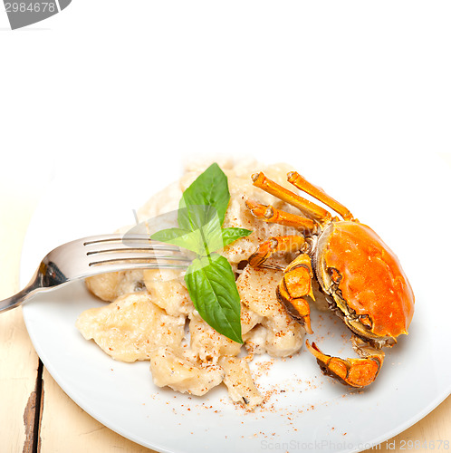 Image of Italian gnocchi with seafood sauce with crab and basil