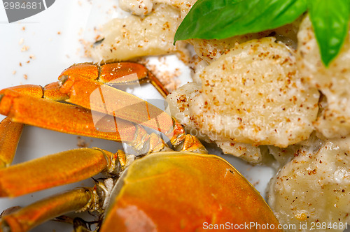 Image of Italian gnocchi with seafood sauce with crab and basil