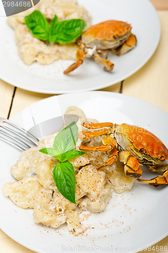 Image of Italian gnocchi with seafood sauce with crab and basil