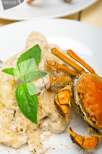 Image of Italian gnocchi with seafood sauce with crab and basil