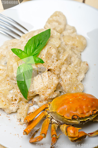 Image of Italian gnocchi with seafood sauce with crab and basil