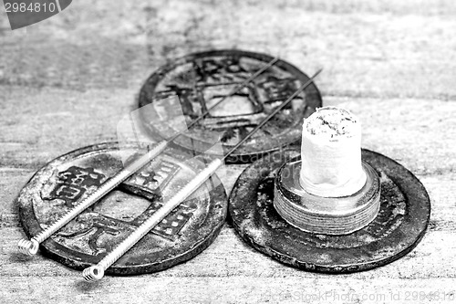 Image of acupuncture needles on antique chinese coin