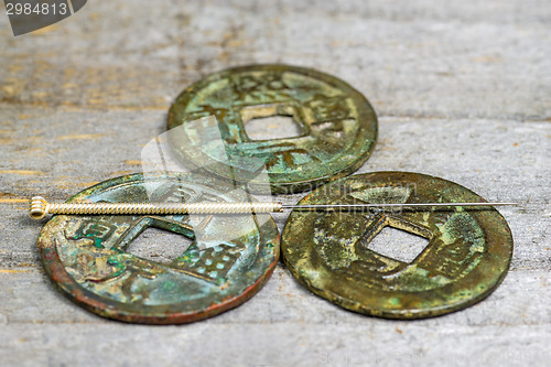 Image of acupuncture needle on antique chinese coin