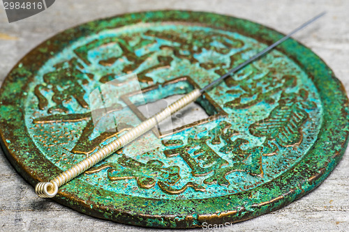 Image of acupuncture needle on antique chinese coin