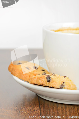 Image of Half cup of coffee with cookies on table