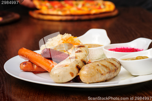 Image of German sausage with cabbage and sauces