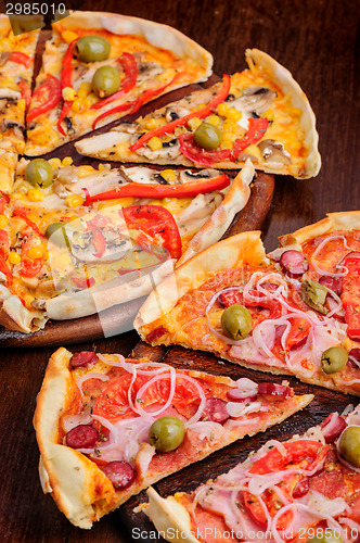 Image of Pizza with tomato, salami, peppeeoni, olives and yellow hot pepper