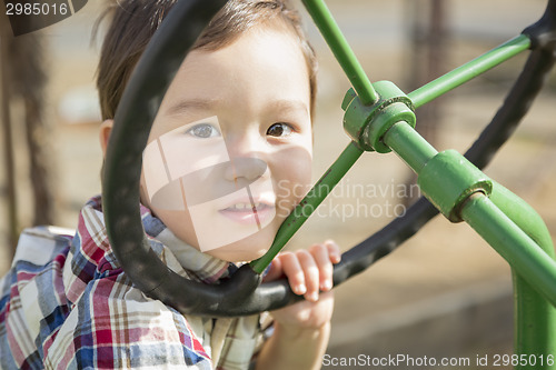 Image of Mixed Race Young Boy Playing on Tractor