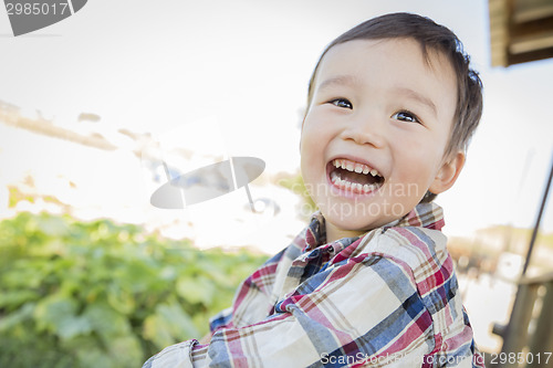 Image of Mixed Race Young Boy Having Fun Outside