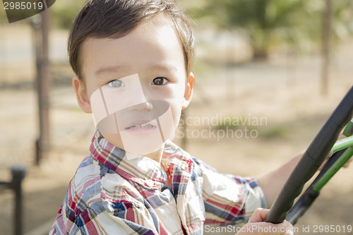 Image of Mixed Race Young Boy Playing on Tractor