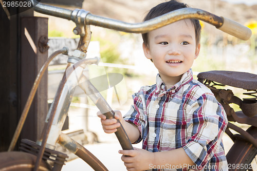 Image of Mixed Race Young Boy Having Fun on the Bicycle