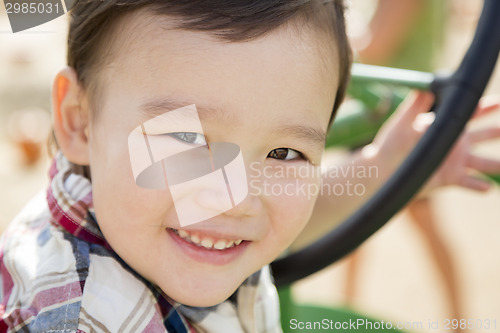 Image of Mixed Race Young Boy Playing on Tractor