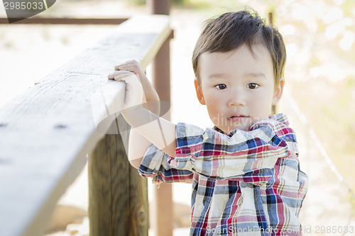 Image of Mixed Race Young Boy Having Fun Outside