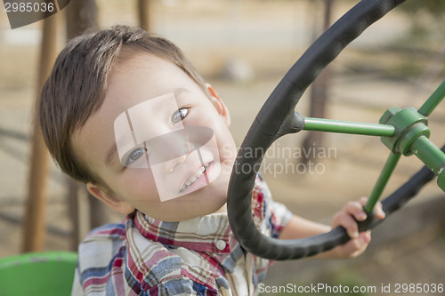 Image of Mixed Race Young Boy Playing on Tractor