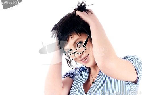 Image of Attractive smiling girl with hands in hair