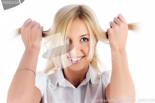 Image of Pretty smiling girl with hands in hair