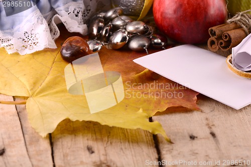 Image of Autumn harvest. Apples, plums, grapes and yellow leaves on white background